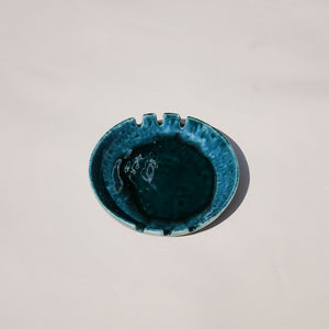 mid century round drip glaze ashtray in teal. made in canada. black dot shops