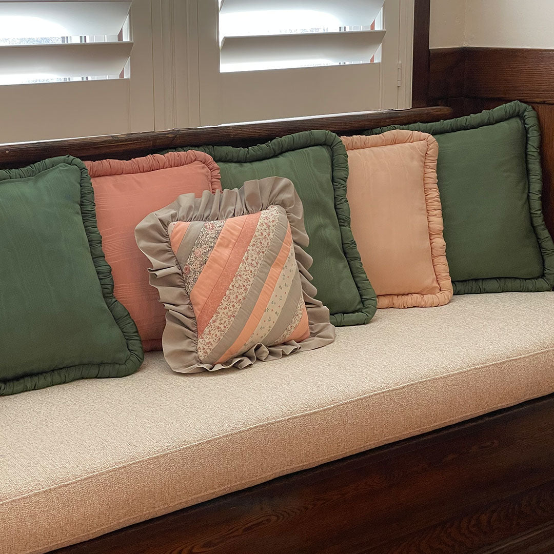 add character to your living space with this rosey pink throw pillow. made with a pearlescent finish, complete with a ruffled edge. 