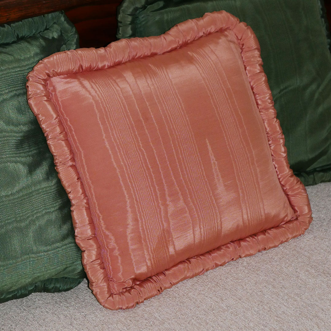 add character to your living space with this rosey pink throw pillow. made with a pearlescent finish, complete with a ruffled edge. 