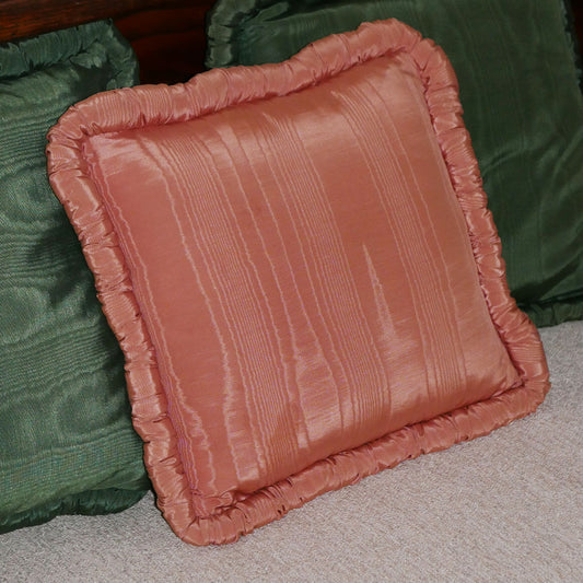 add character to your living space with this rosey pink throw pillow. made with a pearlescent finish, complete with a ruffled edge. 