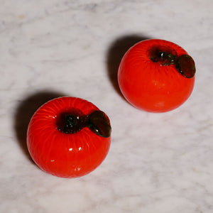 pair of decorative glass tomatoes